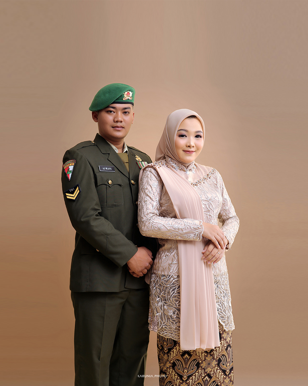 Couple slow dancing in formal wear in an empty ballroom with chandelier lighting